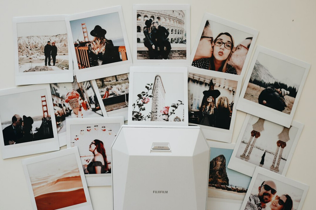 Photographer reviewing printed photographs with a local resident