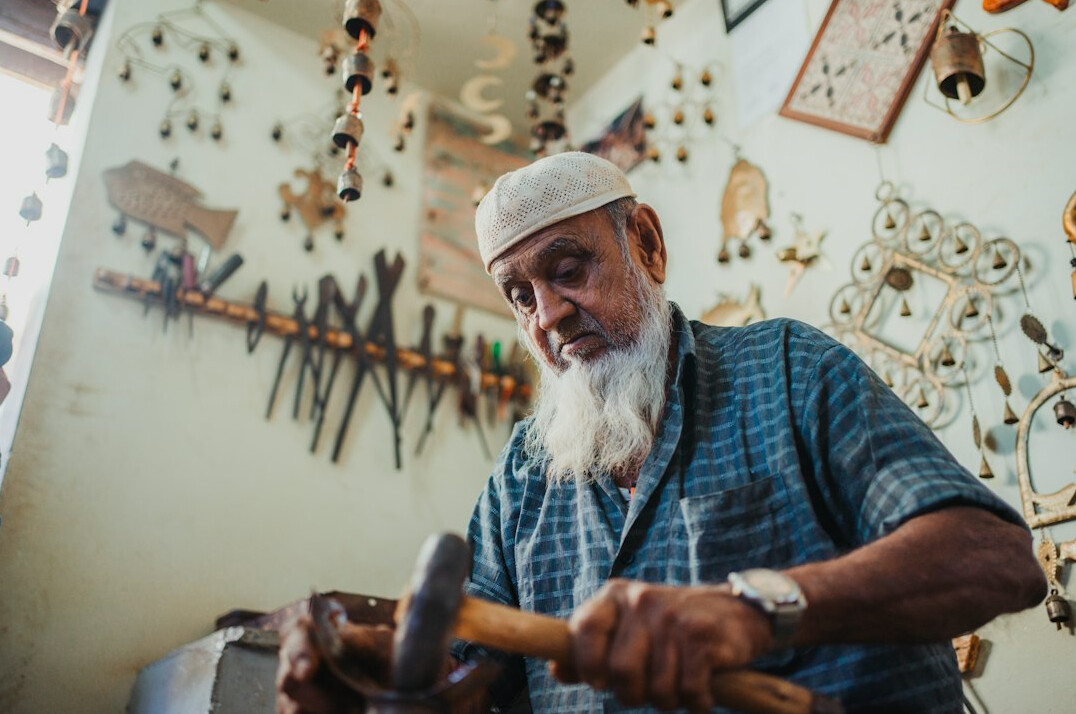 Elderly craftsman working in a traditional workshop